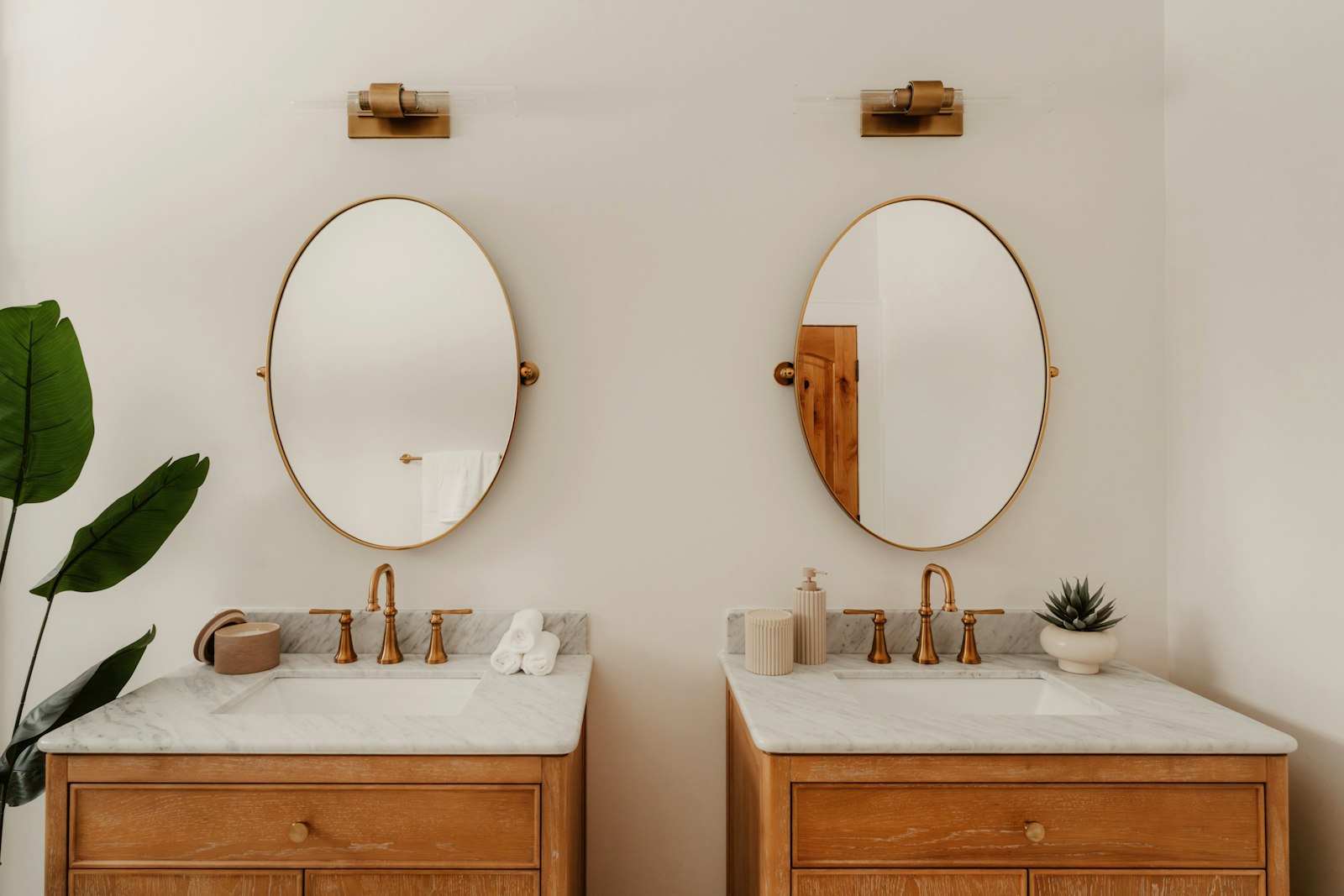 Twin vanities with oval mirrors